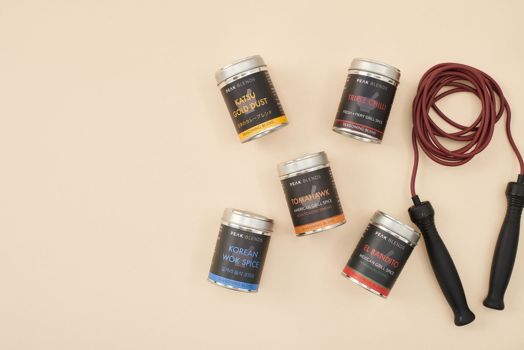 5 peak blends gourmet seasoning blend tins next to coiled up skipping rope