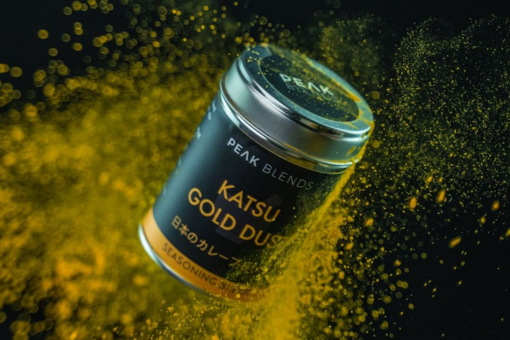 katsu gold dust tin floating on colourful background